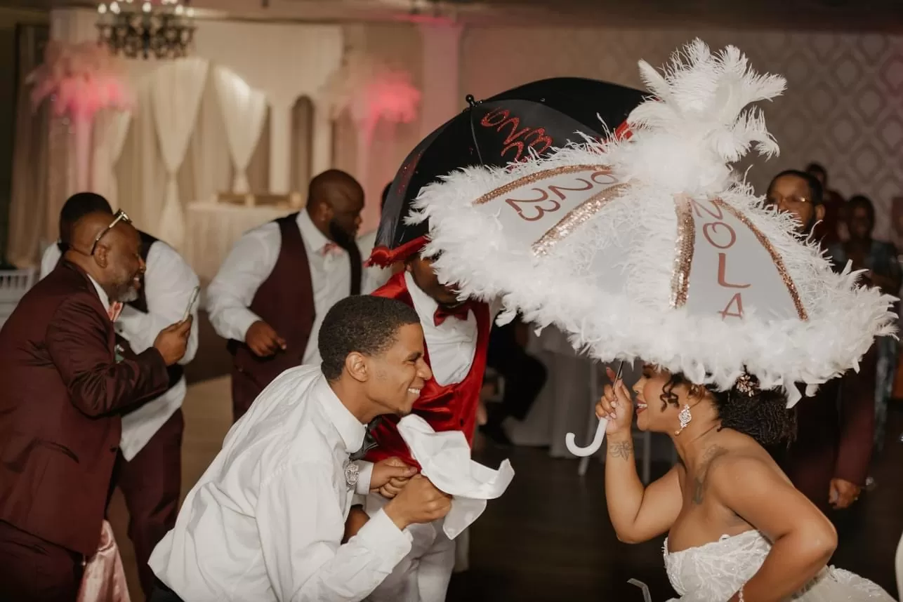 Elegant ballroom wedding reception in New Orleans with chandeliers and dancing couples