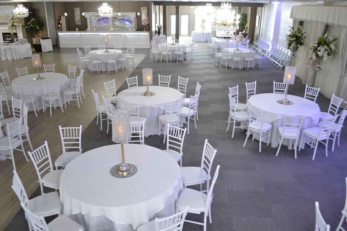Indoor summer wedding reception in New Orleans with elegant decor and guests enjoying local cuisine