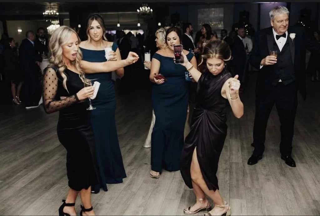 Magnolia Valley Weddings & Events group of women enjoy dancing at a wedding reception.