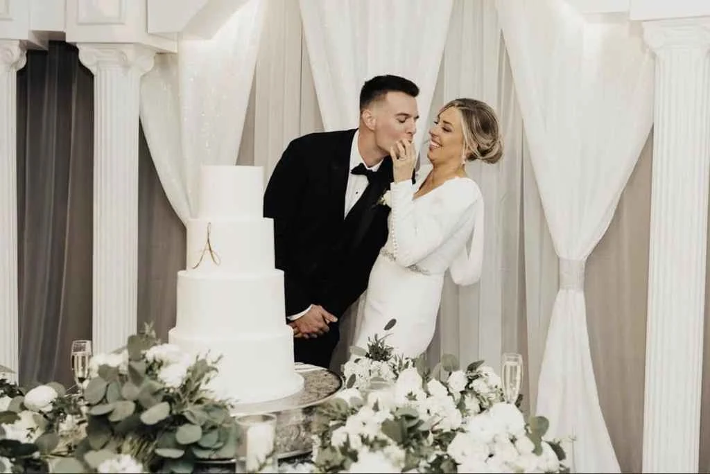 A bride and groom cut their wedding cake at Magnolia Valley Weddings & Events in New Orleans.