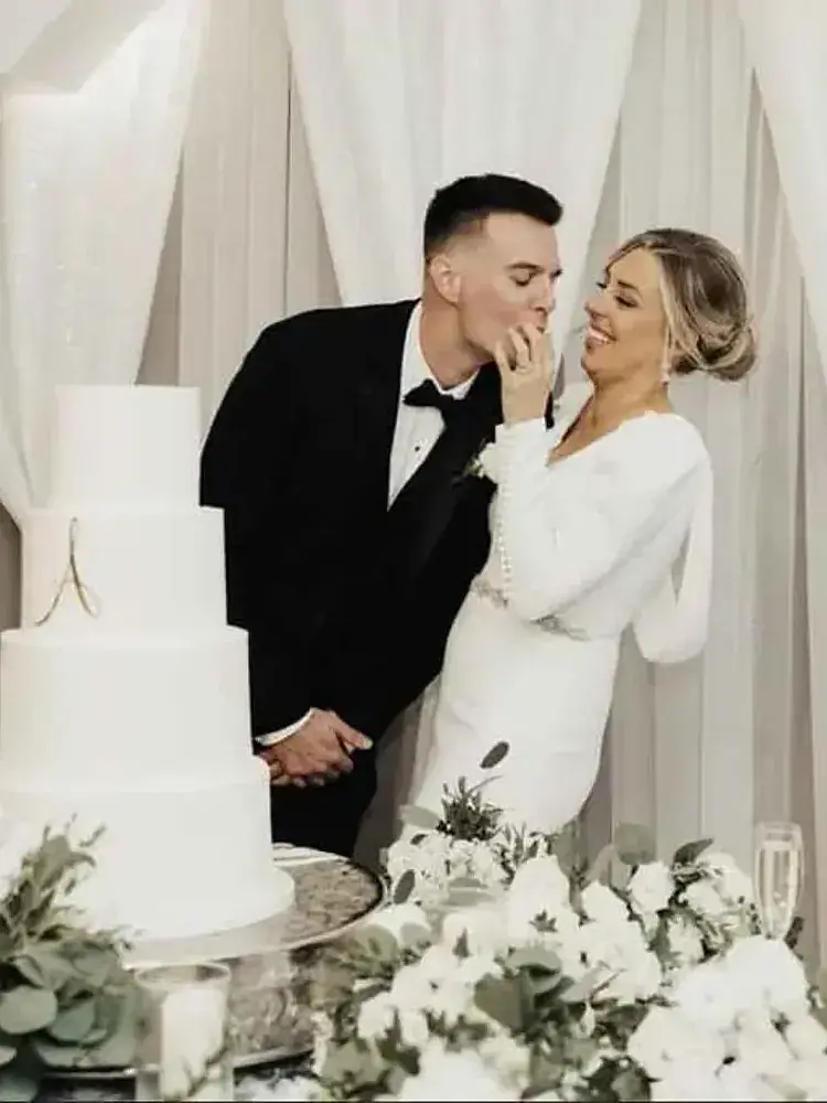 A bride and groom cut their wedding cake at Magnolia Valley Weddings & Events in New Orleans.